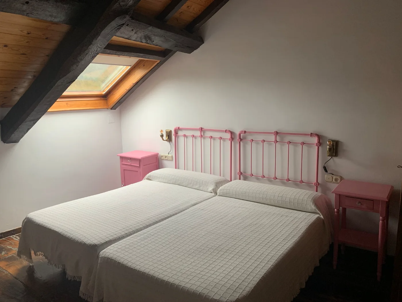 Habitación con dos camas y mesillas verdes